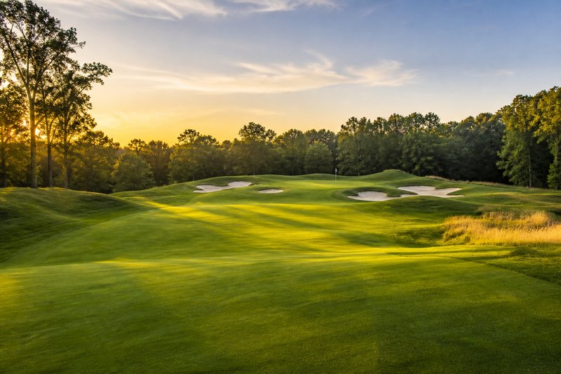Championship golf fairway at golden hour