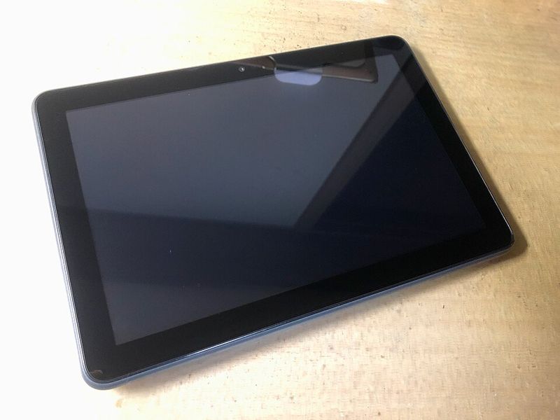 An Amazon Fire HD 8 Plus tablet lying on a wooden table