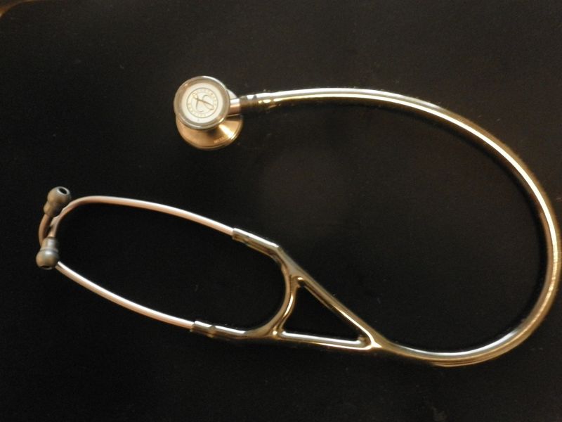 A stethoscope lying on a dark surface