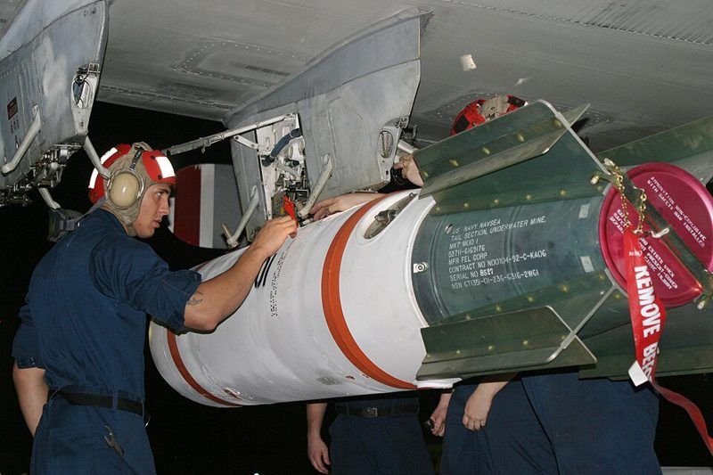 U.S. Navy sailors loading a Mk 65 Quickstrike naval mine onto a P-3C Orion aircraft