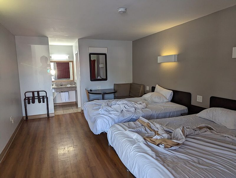 Motel room with a made double bed
