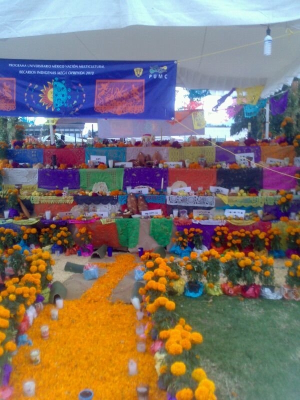 Decorated Day of the Dead ofrenda altar with flowers, candles, and offerings