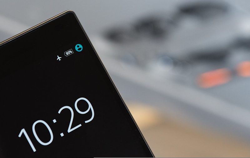 Smartphone lock screen showing the airplane mode icon in the status bar