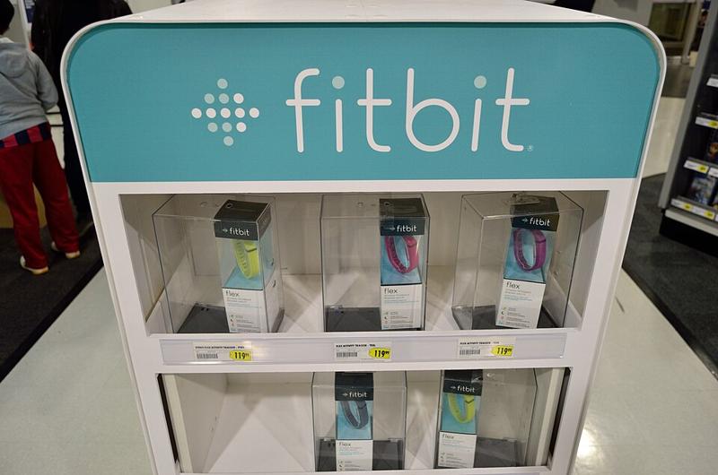 Fitbit fitness trackers on a display stand
