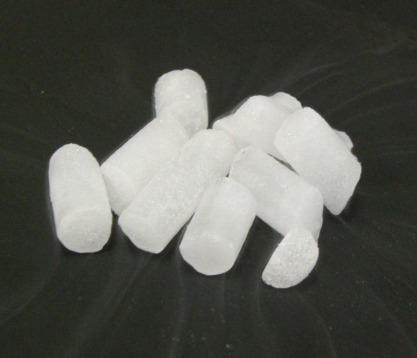 Dry ice pellets giving off white vapor as they sublimate