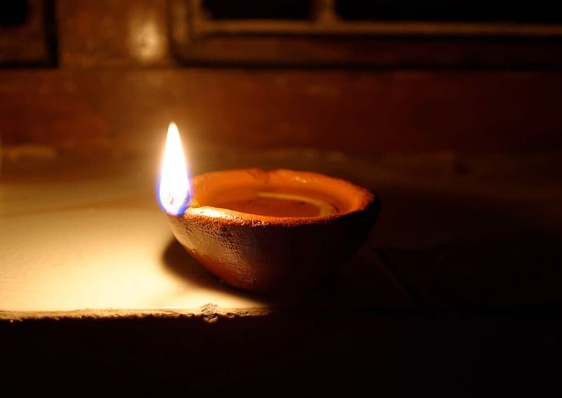 A lit clay diya oil lamp, a traditional Diwali light