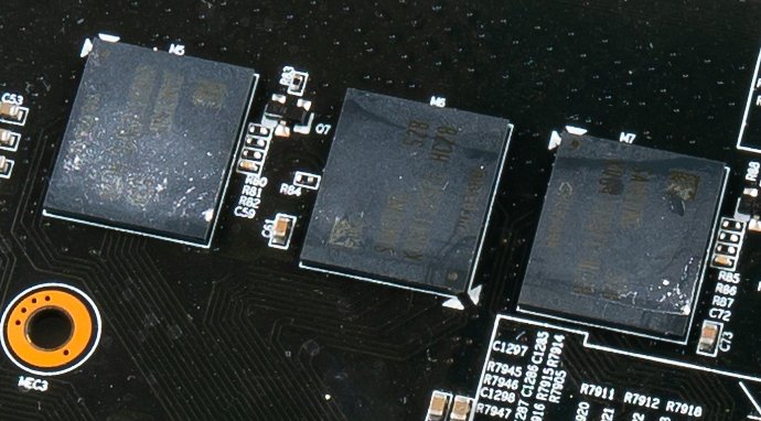 Three GDDR5 graphics memory chips soldered to the circuit board of an Nvidia GeForce GTX 980 Ti graphics card