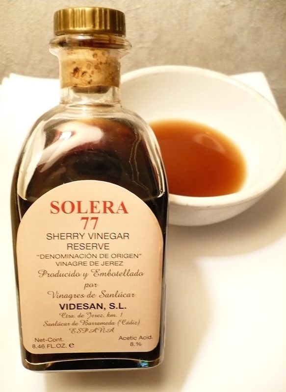 A bottle and a small bowl of sherry vinegar from Sanlucar de Barrameda, Spain