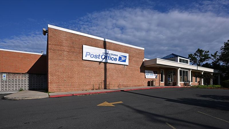 Brick United States Post Office building with a white USPS Post Office sign in Rockville, Maryland