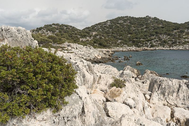 Rocky limestone shoreline and turquoise water at Kekova Island, Turkey