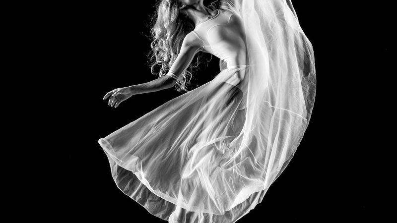 Dancer in motion under stage lights illustrating expressive concert dance