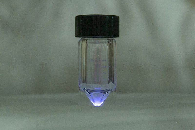 Vial of actinium-225 nitrate glowing blue at Oak Ridge National Laboratory