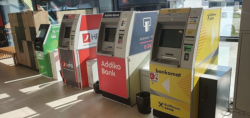 A row of ATMs from several different banks in Croatia (CC0 photo by Gewild, Wikimedia Commons)