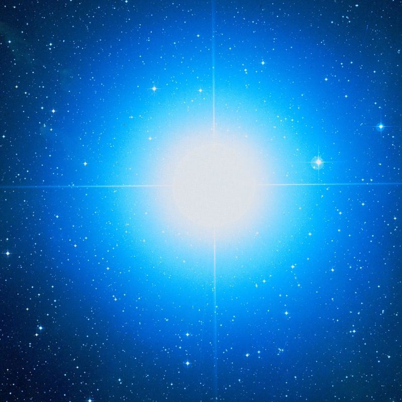 The blue supergiant star Rigel glowing bright blue-white against a field of fainter stars