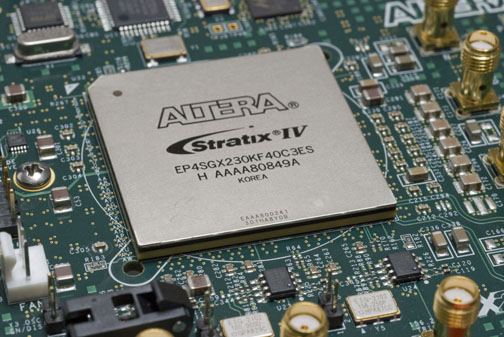 Close-up of an Altera Stratix IV FPGA chip mounted on a green circuit board