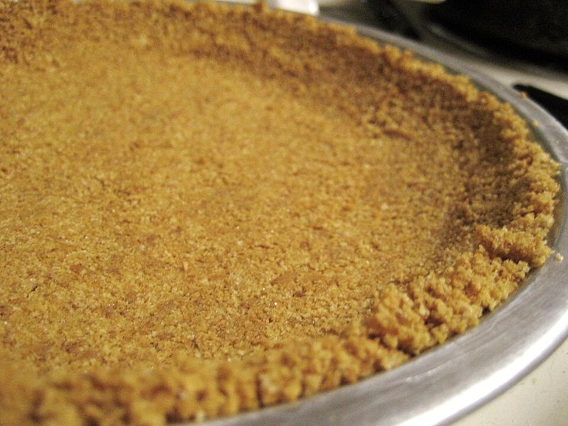 Unbaked graham cracker crumb crust pressed into a metal pie pan