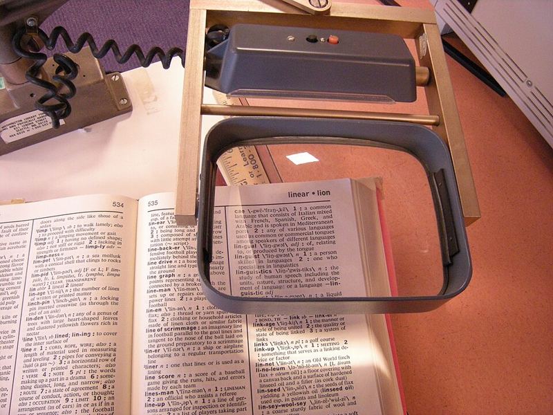 Magnifier mounted over a dictionary page at a library for blind and low-vision readers