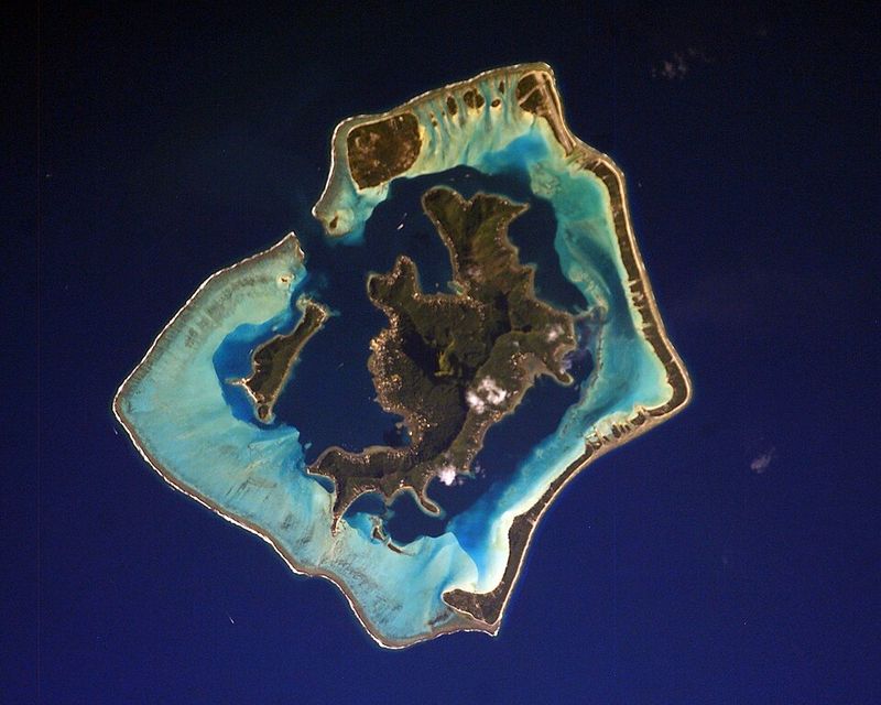 Astronaut photo of Bora Bora, a volcanic island ringed by a lagoon and a barrier reef