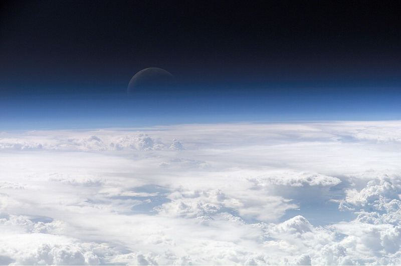 Thin blue layer of Earth’s atmosphere above clouds, photographed from the International Space Station