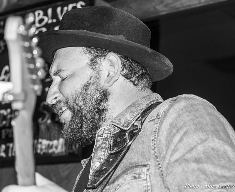 Blues guitarist Josh Smith playing electric guitar on stage