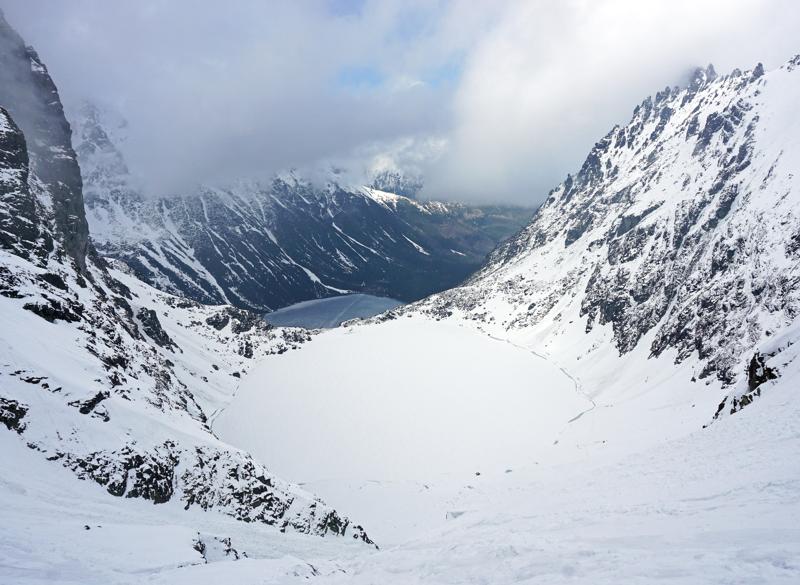 Two Tatra mountain lakes at different elevations, the higher one still frozen
