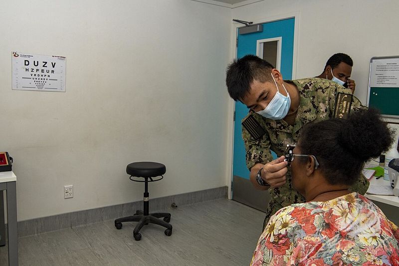 Navy optometrist conducting an eye examination on a patient