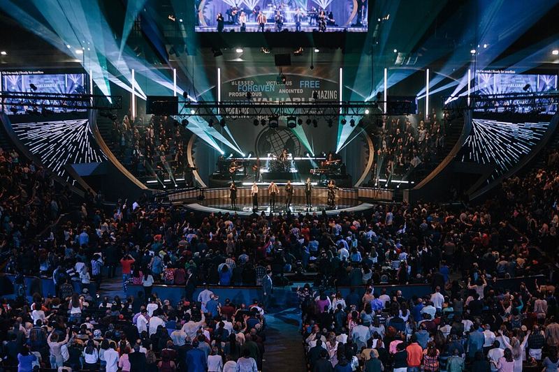 A large crowd at a worship service in Lakewood Church's arena-style sanctuary in Houston