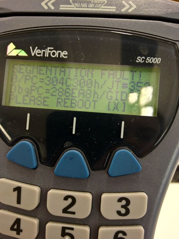 VeriFone card payment terminal screen displaying a Segmentation Fault error and a prompt to reboot