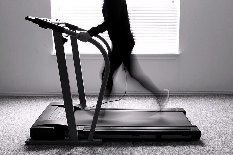 Man running on an exercise treadmill in a gym