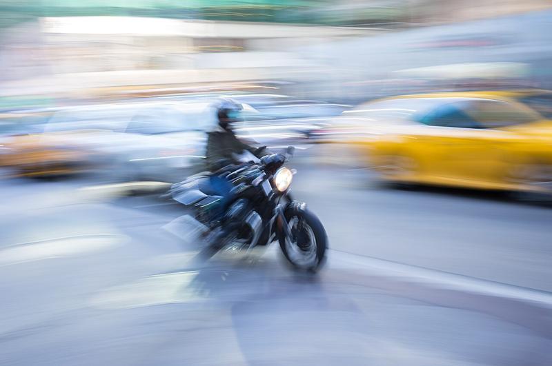 A motorcyclist moving through Midtown Manhattan
