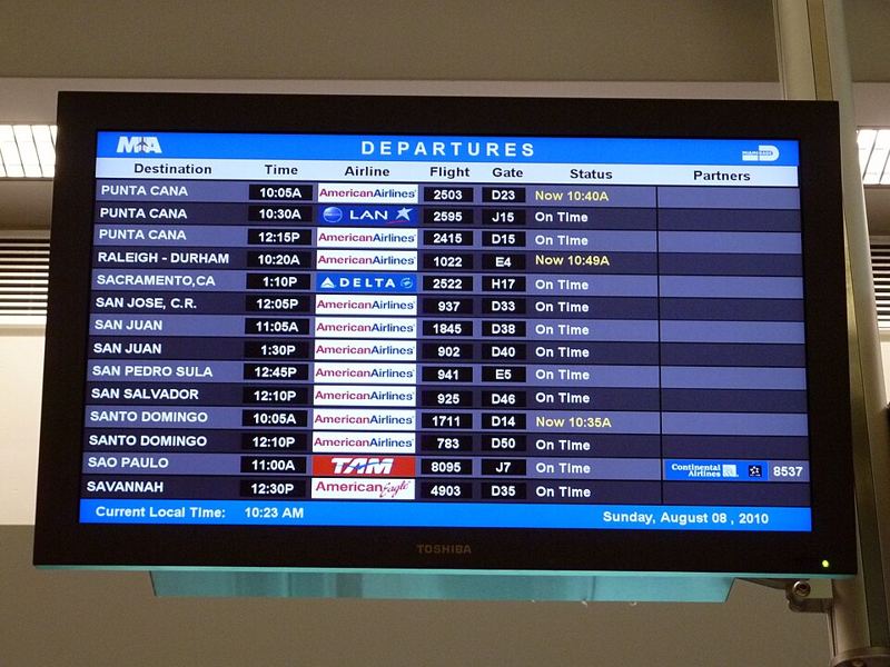 Airport departures board listing flights and gate times