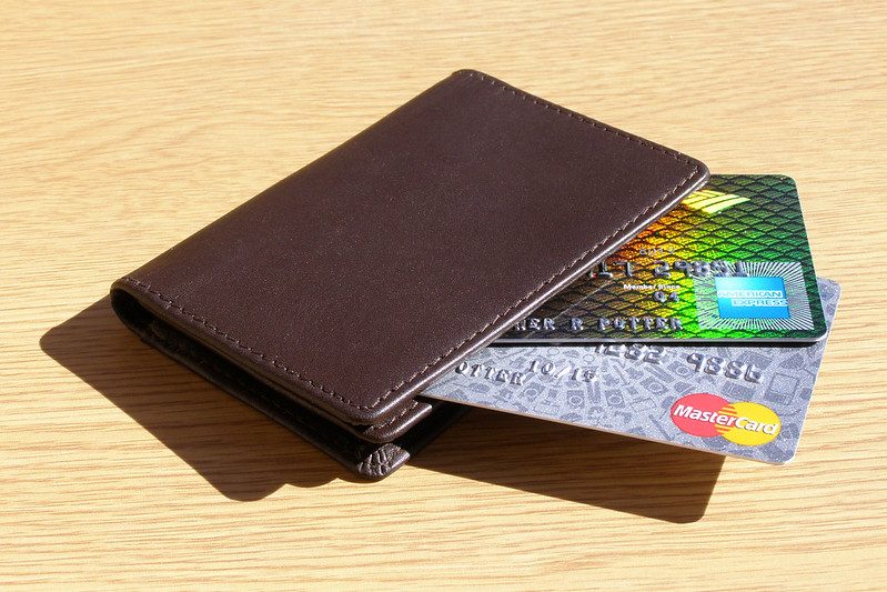 Several credit cards tucked into the slots of a leather wallet