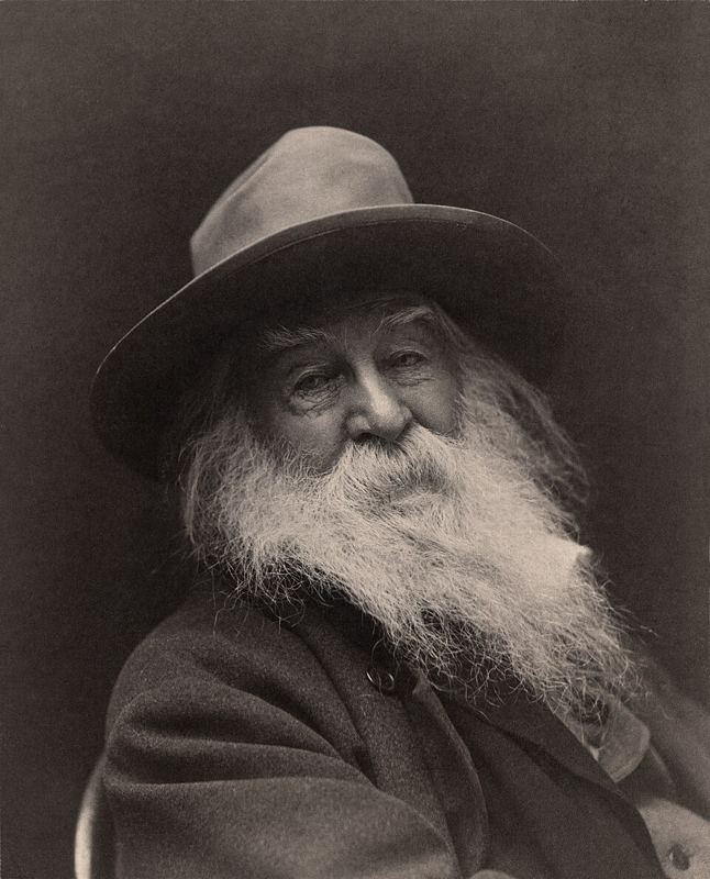 Portrait photograph of poet Walt Whitman with a white beard, taken in 1887