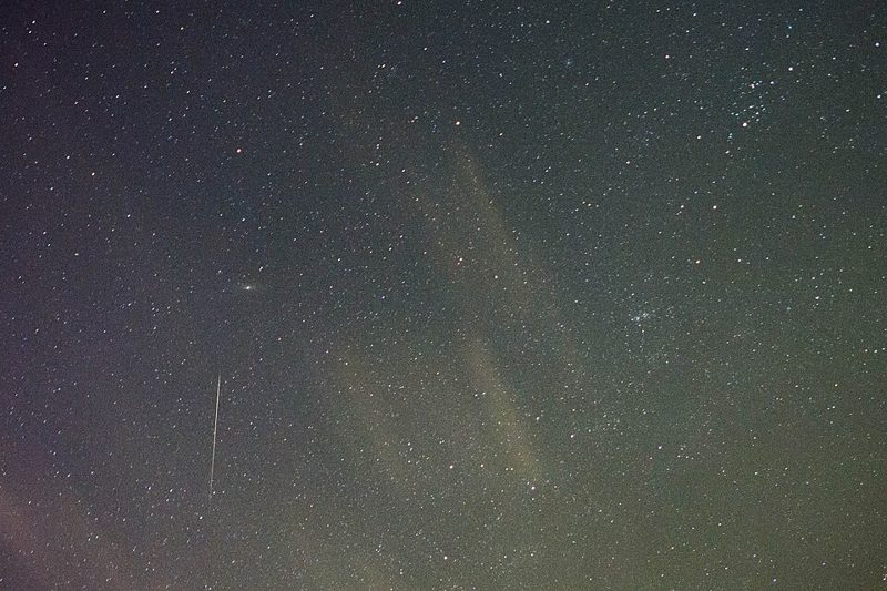 A bright Orionid meteor streaking across a star-filled night sky