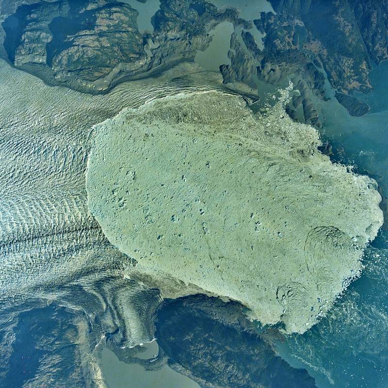 Aerial view of the calving front of Alaska's Columbia Glacier ending in water, 1991